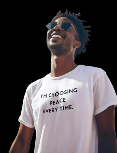 Man in a white 'CHOOSING PEACE' tee and wearing black Glasses