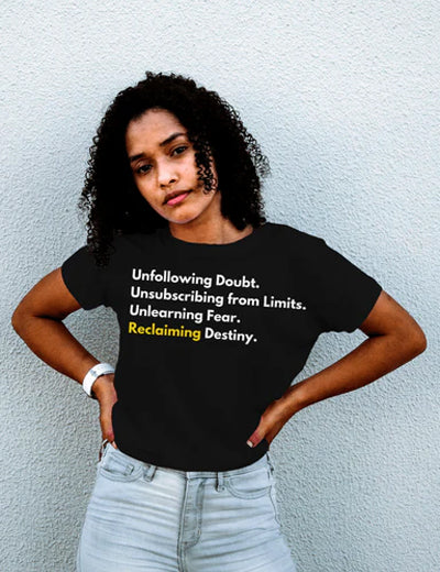 Women in a black motivational tee and blue jeans