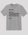 Gray tee with prayer written in black text and a golden symbol on sleeve 