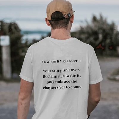 Person in cap and motivational tee at beach